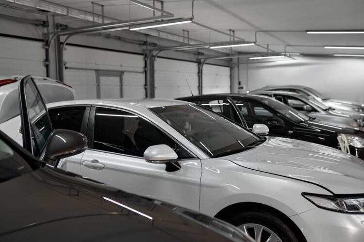 Different car drying after painting and polishing. Automobile range in booth. Auto in repair shop