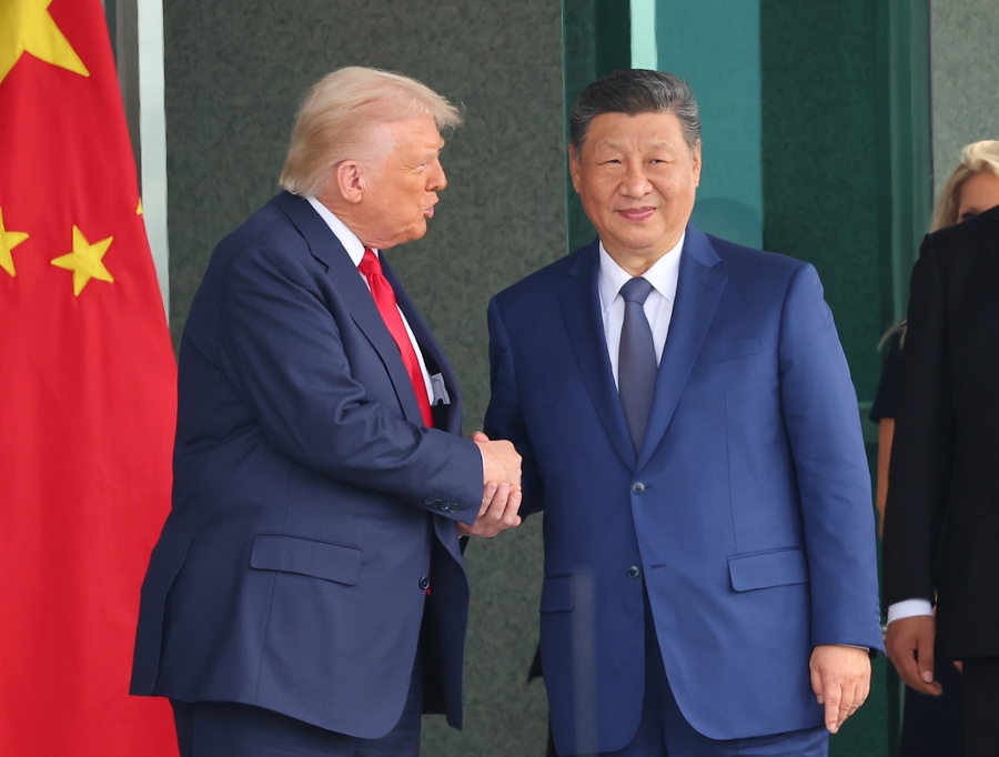 epa12492372 US President Donald Trump (L) and Chinese President Xi Jinping (C) shake hands following their meeting at the Naraemaru reception hall inside an Air Force base in Busan, South Korea, 30 October 2025. EPA/YONHAP SOUTH KOREA OUT