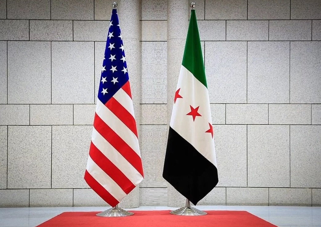 American and Syrian flag standing on the table with defocused background