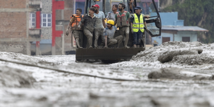 epa13193024 Rescuers ride in an excavator at Devighat village following a flash flood in Trishuli Bazar, Nuwakot district, Nepal, 26 August 2026. Several people were killed and multiple others were reported missing after a massive flash flood swept through Rasuwa and Nuwakot districts causing widespread destruction to settlements and infrastructure, according to local authorities.  EPA/NARENDRA SHRESTHA